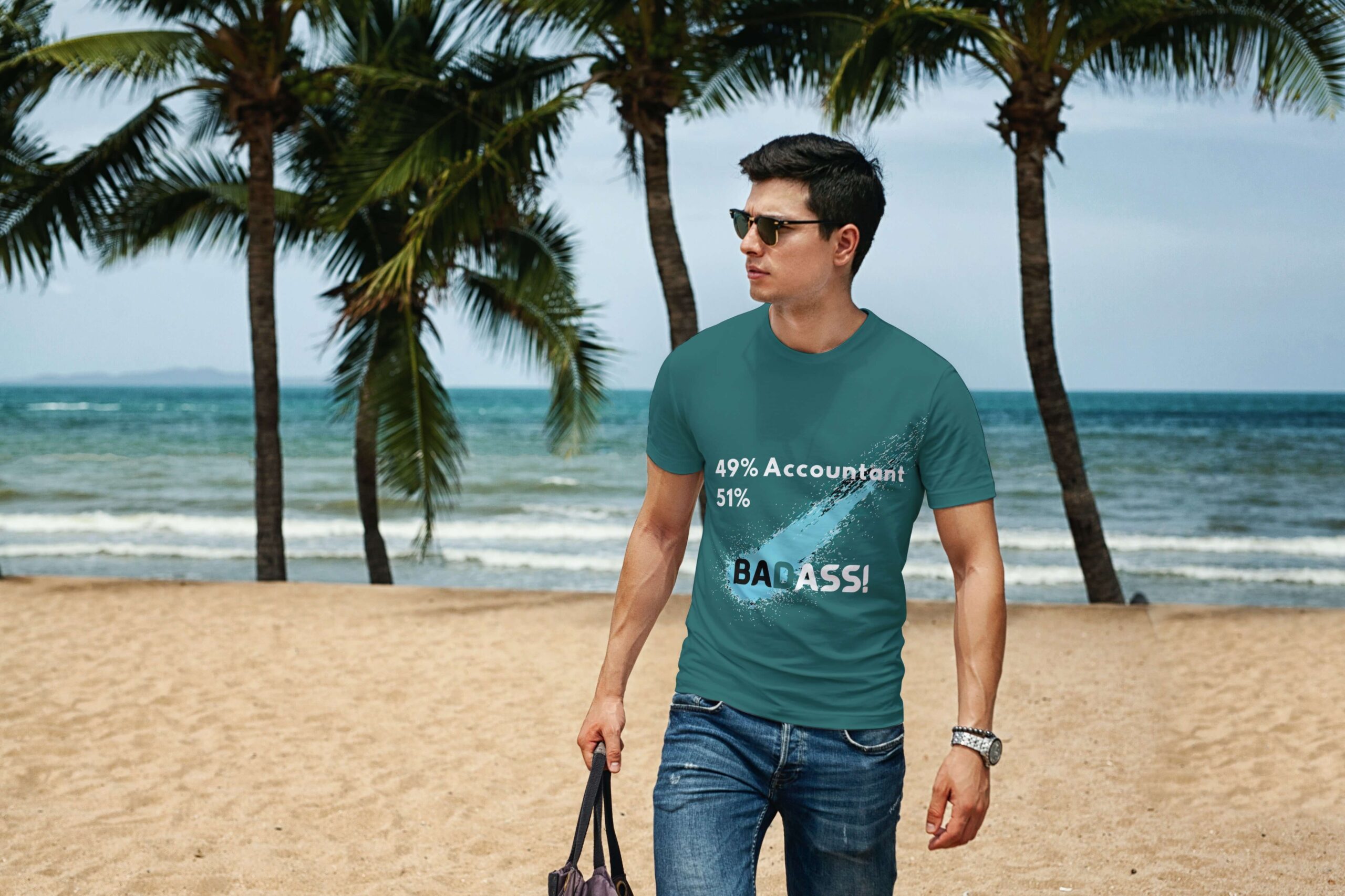 Man walking on the beach in an accountancy t-shirt